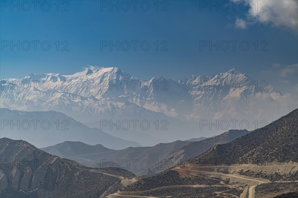 Desert mountain scenery with the Annapurna mountain range in the background, Kingdom of Mustang, Nepal, Asia