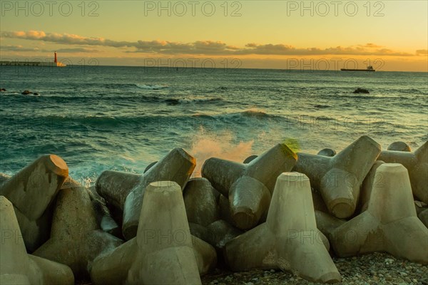 Seascape with concrete tetrapods on breakwater during dusk, creating a tranquil scene, in South Korea