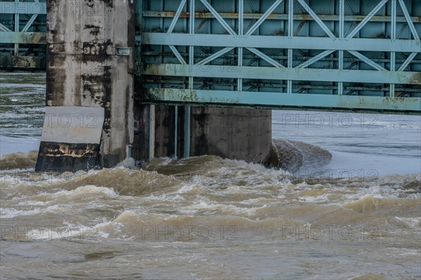 Closeup of dam with water surging through open floodgates after torrential monsoon rains in Daejeon South Korea