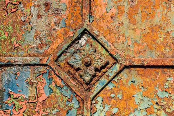 Close-up of a corroded metallic surface with square patterns and peeling paint, Mettmann, North Rhine-Westphalia