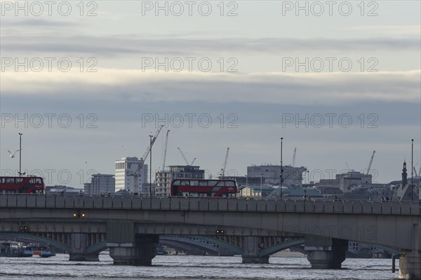 Red bus crosses over London Bridge, City of London, England, United Kingdom, Europe