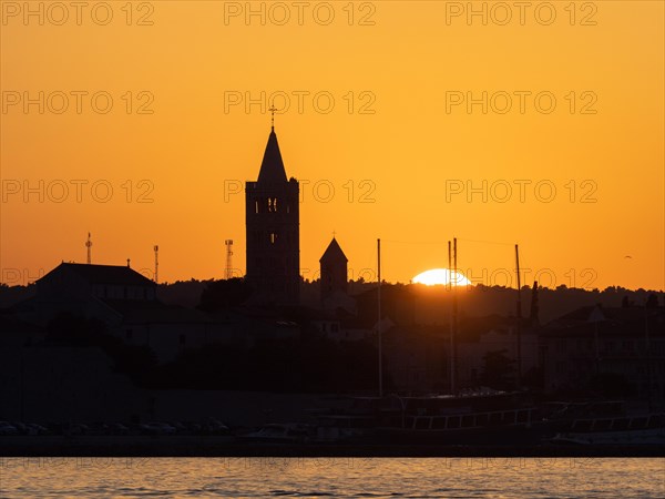 Golden evening light at sunset, silhouette of the church towers of Rab, town of Rab, island of Rab, Kvarner Gulf Bay, Croatia, Europe