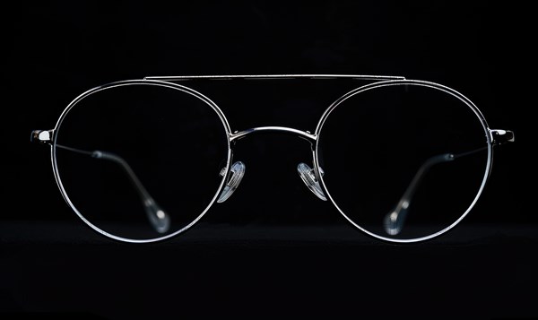 Contrasting silhouette of aviator sunglasses with a white outline on dark background AI generated