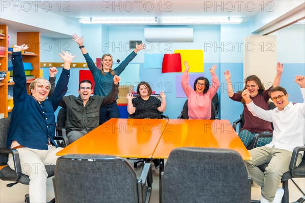 Portrait of happy joyful people with special needs in a class with teacher