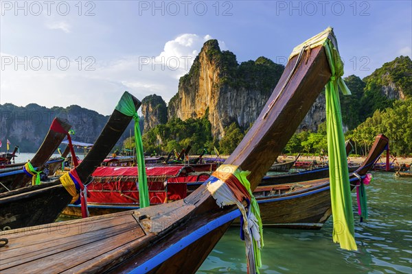 Longtail boat for transporting tourists, water taxi, taxi boat, ferry, ferry boat, fishing boat, wooden boat, boat, decorated, tradition, traditional, bay, sea, ocean, Andaman Sea, tropics, tropical, chalk cliffs, landscape, island, water, travel, tourism, paradisiacal, beach holiday, sun, sunny, holiday, dream trip, holiday paradise, paradise, coastal landscape, nature, idyllic, turquoise, Siam, exotic, travel photo, Krabi, Thailand, Asia