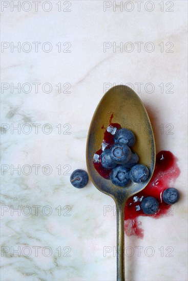 Blueberries and blueberry jam in spoons, blueberry