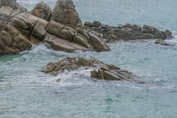 Dynamic view of the sea hitting a rocky coast with overcast conditions, in South Korea