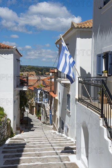 A narrow alley with a staircase between traditional white houses under a blue sky, Koroni, Pylos-Nestor, Messinia, Peloponnese, Greece, Europe