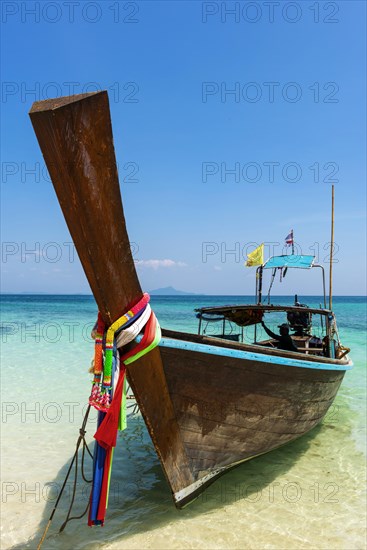 Longtail boat, fishing boat, wooden boat, boat, decorated, tradition, traditional, faith, cloth, colourful, bay, sea, ocean, Andaman Sea, tropics, tropical, island, water, beach, beach holiday, Caribbean, environment, clear, clean, peaceful, picturesque, sea level, climate, travel, tourism, paradisiacal, beach holiday, sun, sunny, holiday, dream trip, holiday paradise, paradise, coastal landscape, nature, idyllic, turquoise, Siam, exotic, travel photo, sandy beach, seascape, Phi Phi Island, Thailand, Asia