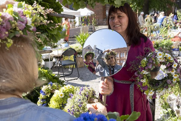 Riga. Ligo festival. Binding of midsummer wreaths. Flower wreaths, stalls in the city square, Riga, Latvia, Europe