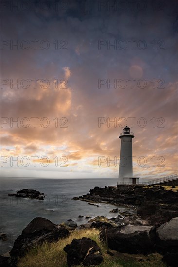 White lighthouse on a steep coast. Dramatic clouds with a view of the sea, pure Caribbean at Le Phare du Vieux-Fort, on Guadeloupe, French Antilles, France, Europe