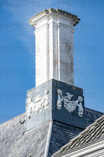 White chimney with ornate decorations on a slate roof, Middelburg, Zeeland, Netherlands