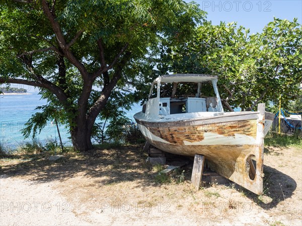 Old wooden boat on land under a tree, island of Rab, Kvarner Gulf Bay, Croatia, Europe