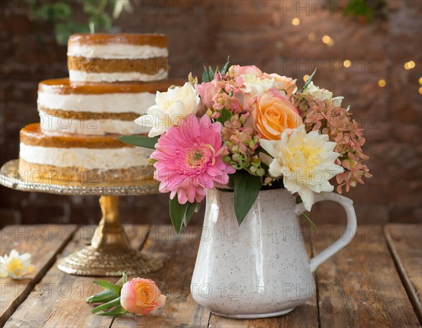 Elegant cake for Mother's Day next to a pretty flower arrangement on a table, AI generated, AI generated