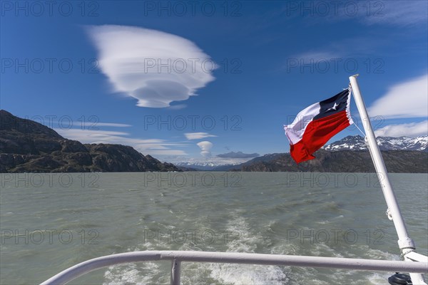 Boat trip, glacial lake, flag, cloud, UFO, Lago Grey, Torres del Paine National Park, Parque Nacional Torres del Paine, Cordillera del Paine, towers of the blue sky, Region de Magallanes y de la Antartica Chilena, Ultima Esperanza province, UNESCO biosphere reserve, Patagonia, end of the world, Chile, South America