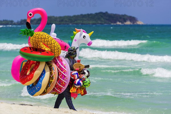 Merchant on the beach selling inflatable swimming aids, colourful, swimming, beach vendor, holiday, symbol, symbolic, rubber animals, inflatable, swimming figures, plastic, synthetic, summer, sun, fun, bathing, swimming, children's toy, bathing fun, pleasure, bathing holiday, summer holiday, neon colours, play, childhood, swimming ring, lifebuoy, water toy, Koh Samui, Thailand, Asia