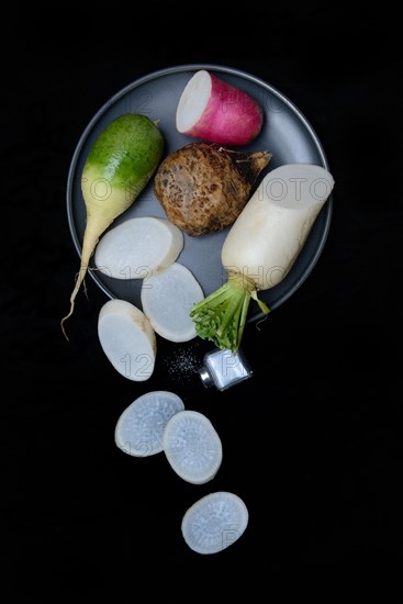 Various radishes on a plate, sliced, Raphanus