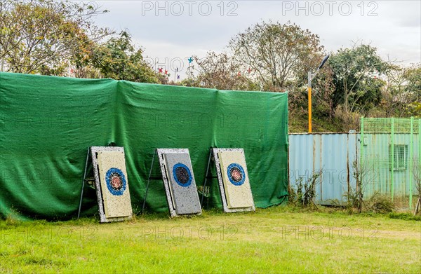 An outdoor archery range with several targets lined up against a fence, in South Korea