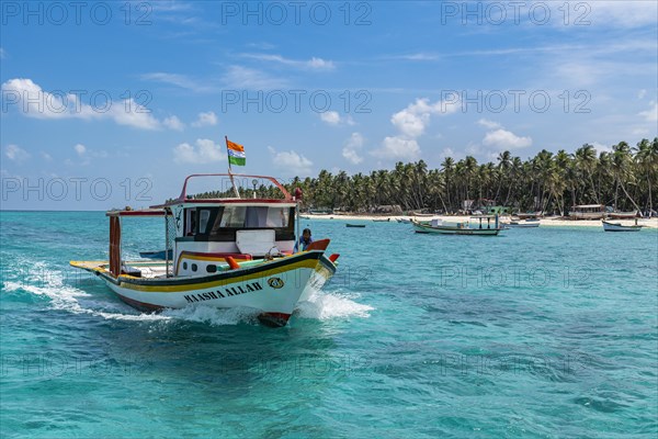 Little boats before a palm fringed white sand beach, Agatti Island, Lakshadweep archipelago, Union territory of India