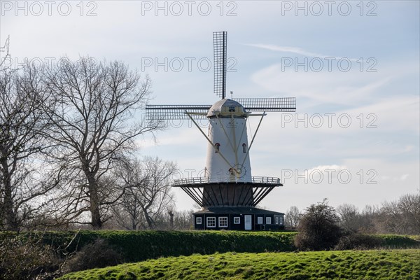 White-blue windmill stands in front of a partly cloudy sky, Veere, Zeeland, Netherlands