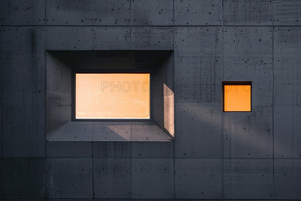 Minimalistic modern concrete architecture with geometric windows at sunset, AI generated