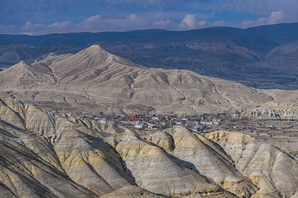 Lo Manthang, capital of Upper Mustang, viewed from a distance amidst a barren desertic landscape, Kingdom of Mustang, Nepal, Asia