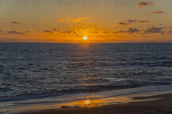 Dramatic sunset over the sea with radiant light and reflections on the water, Finikounda, Pylos-Nestor, Messinia, Peloponnese, Greece, Europe