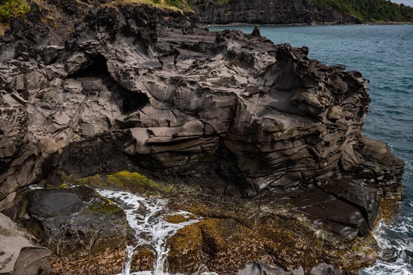 Nature in a special landscape. A rocky coast by the sea. Great landscape shot of cliffs in the Caribbean, the waves crashing against the island of Guadeloupe in the French Antilles