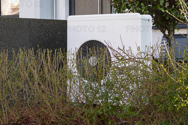 Heat pump in the front garden of a terraced house in Duesseldorf, North Rhine-Westphalia, Germany, Europe