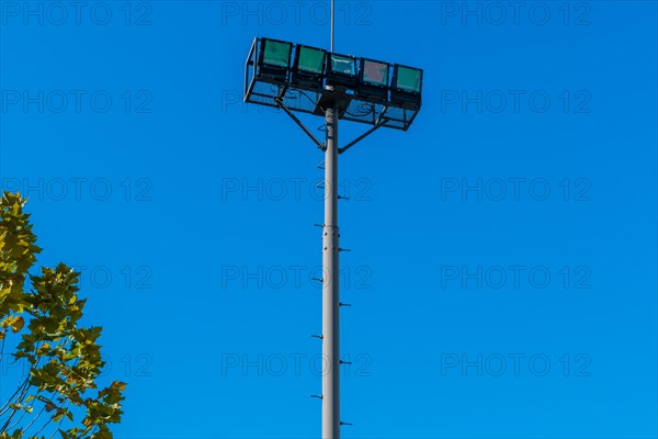 Aerial lift cabin suspended against a clear blue sky near green foliage, in South Korea