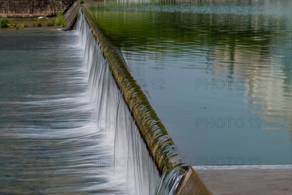 Water cascades down a spillway, creating a smooth waterfall effect, in South Korea