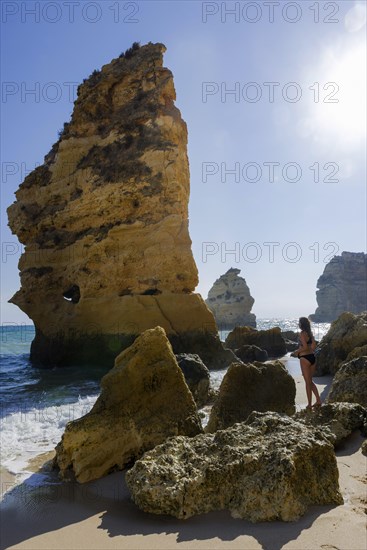 Young woman on summer holiday, emotion, rock, distance, view, sun, summer, summer holiday, holiday happiness, tourism, travel, symbolic, symbol, beach holiday, freedom, feeling of freedom, beach holiday, Algarve, Portugal, Europe