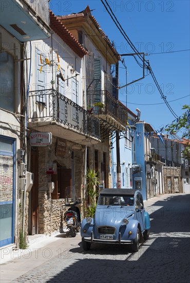 A quiet alleyway scene with old buildings, a vintage car and a motorbike, Citroen 2 CV, duck, vintage car, alley in the old town, Koroni, Pylos-Nestor, Messinia, Peloponnese, Greece, Europe