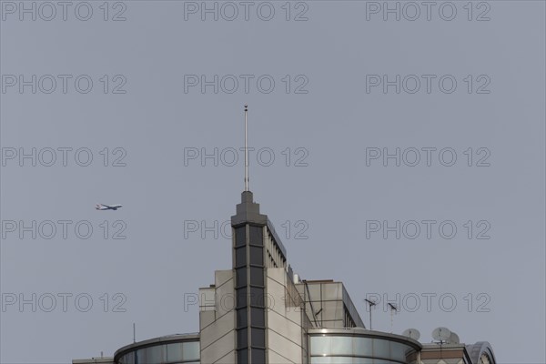 Airbus A319-100 aircraft of British airways in flight over a city skyscraper building, London, England, United Kingdom, Europe