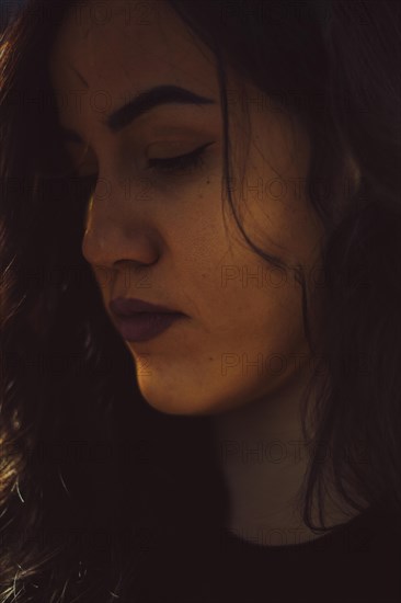 Close-up of a woman's face in a moody, introspective ambiance, a complete tool panel in background with bokeh effect, traditional male jobs by Mixed-race latino woman