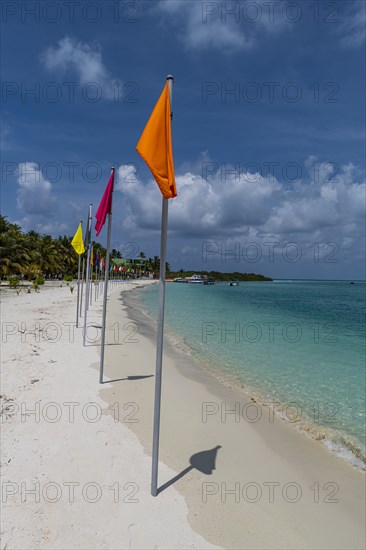 White sand beach with many flags, Bangaram island, Lakshadweep archipelago, Union territory of India