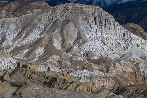 Eroded sandstone houses in barren mountain landscape, Kingdom of Mustang, Nepal, Asia