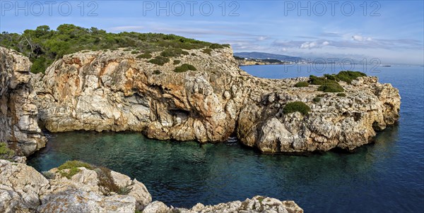 Wide view of rugged rock formations along a serene Mediterranean coastline, Coastal Hiking tour in the south of Mallorca