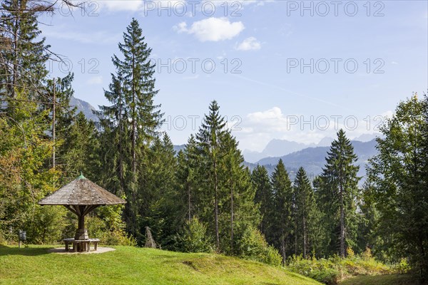 Karwendel mountains with forest and shelter with benches, in autumn, hiking trail Kramerplateauweg, Garmisch-Partenkirchen, Upper Bavaria, Bavaria, Germany, Europe