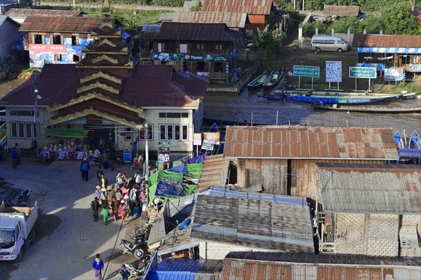 Urban scene with people moving close to buildings and market stalls, Pindaya, Inle Lake, Myanmar, Asia