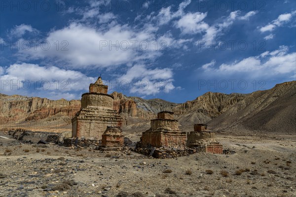 Colourfully painted Buddhist stupa, in a eroded mountain landscape, Kingdom of Mustang, Nepal, Asia