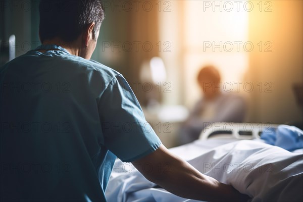 Back view of male nurse in blue medical scrub in horpital or retirement home. KI generiert, generiert AI generated