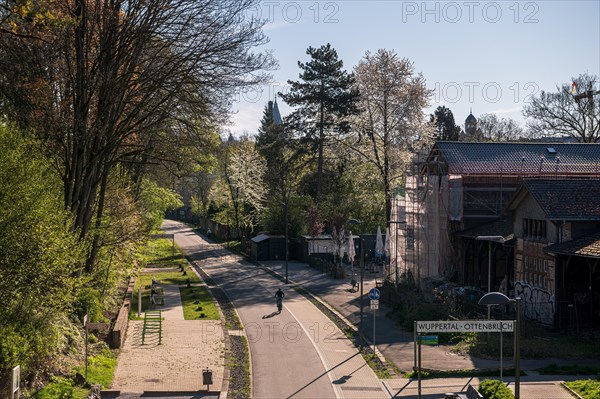 Urban leisure path in spring with a person walking in the shade, cycle path, Nordbahntrasse, Elberfeld, Wuppertal, Bergisches Land, North Rhine-Westphalia