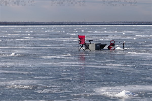 Winter riverscape, chair on an ice surface, Saint Lawrence River, Province of Quebec, Canada, North America