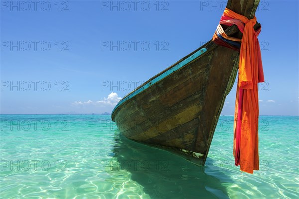 Longtail boat, fishing boat, wooden boat, decorated, tradition, traditional, faith, cloth, colourful, bay, sea, ocean, Andaman Sea, tropical, tropical, island, water, beach, beach holiday, Caribbean, environment, clear, clear, clean, peaceful, picturesque, sea level, climate, travel, tourism, paradisiacal, beach holiday, sun, sunny, holiday, dream trip, holiday paradise, paradise, coastal landscape, nature, idyllic, turquoise, Siam, exotic, travel photo, sandy beach, seascape, Phi Phi Island, Thailand, Asia