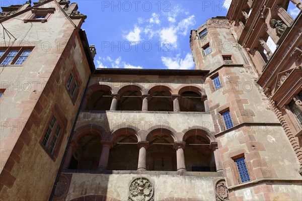 Part of a castle (Heidelberg Castle), with rows of arches made of red sandstone under a clear sky, Heidelberg, Baden-Wuerttemberg, Germany, Europe