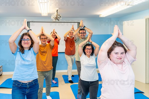 Disabled group of people practicing yoga together in a gym with good vibes