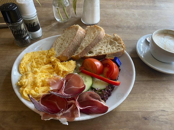 Food, breakfast, scrambled eggs, bread, South Tyrolean ham, tomatoes, cucumber, cappuccino, salt, pepper, Stuttgart, Baden-Wuerttemberg, Germany, Europe