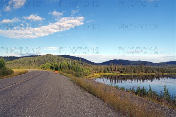 Traffic-free road leads through tranquil lakes and forests, late summer, Alaska Highway, Yukon Territory, Canada, North America