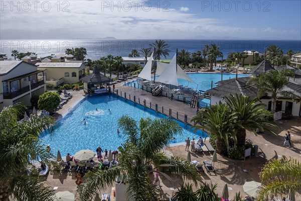 View of garden and pool facilities by the Atlantic Ocean, Hotel H10 Rubicon Palace, Lanzarote, Canary Island, Spain, Europe